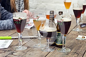 Straffe Hendrik and Brugse Zot belgian beers on wooden table