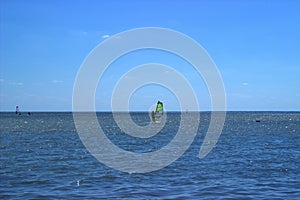 A straggler in a windsurfer regatta