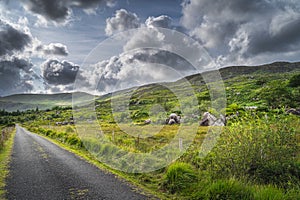 Straight country road leading trough rough landscape of Molls Gap in MacGillycuddys Reeks mountains