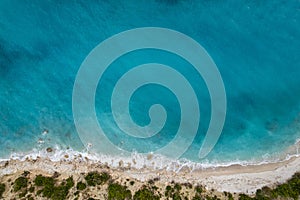 Straight down view on waves on rocky shore by Bunec Beach area in Summer 2022, Albania