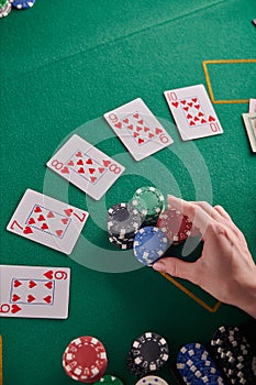 A straight flush, laid out on the table and a lot of chips. Poker, Casino, Winning combination. Player raises bets and wins