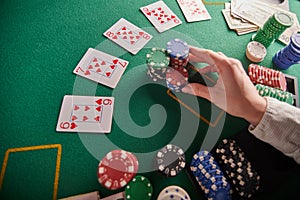 A straight flush, laid out on the table and a lot of chips. Poker, Casino, Winning combination. Player raises bets and wins