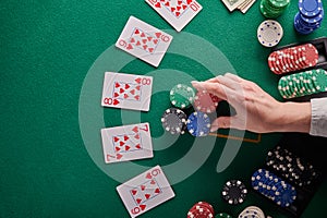 A straight flush, laid out on the table and a lot of chips. Poker, Casino, Winning combination. Player raises bets and wins