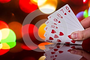 Straight flush poker cards combination on blurred background casino luck fortune card game