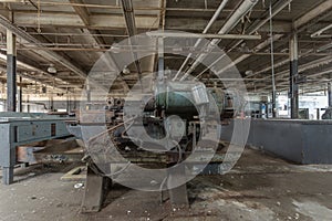 Straight on photo of industrial machine left abandoned in a factory