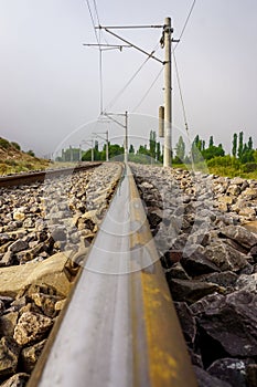 Straight railroad on a foggy morning, vertical shot