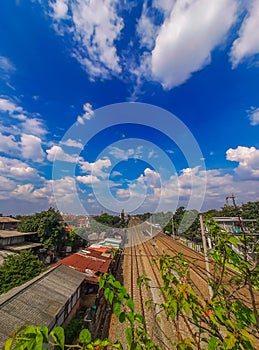 straight railroad tracks in residential jakarta