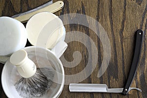 Straight razors with mug and cream background