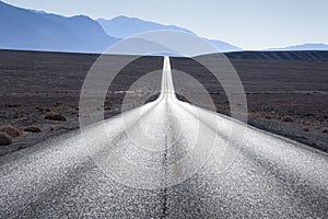 Straight road in American desert, Death Valley, California, USA