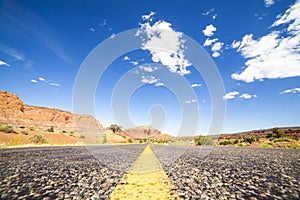 Straight road through empty wilderness in Utah