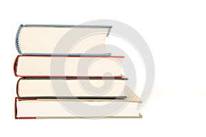 Straight staple of four books seen from the front isolated on a