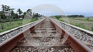 straight train tracks. horizontal iron. transportation. railroad gravel. view of the railroad. straight object