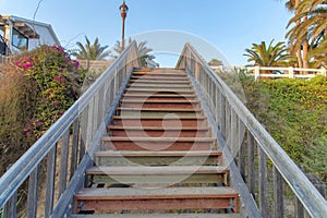 Straight upstairs with wooden steps and railings at Oceanside, California