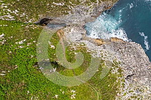 Straight view down above the holes of Jesters bufones of arenillas, Spain near city Llanes in August 2023