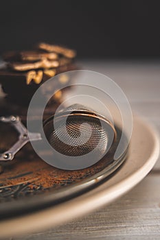 strainer with cocoa powder on a gray plate