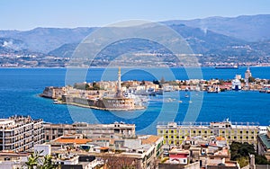 The Strait of Messina between Sicily and Italy. View from Messina town with golden statue of Madonna della Lettera and