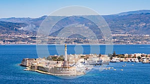 The Strait of Messina between Sicily and Italy. View from Messina town with golden statue of Madonna della Lettera and