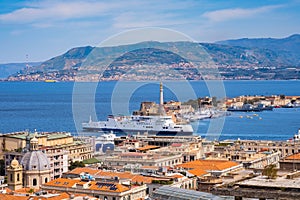 The Strait of Messina between Sicily and Italy. View from Messina town with golden statue of Madonna della Lettera and