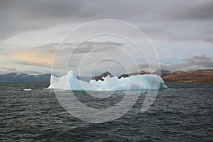 Stranded iceberg and ice near evening in arctic landscape, near Pond Inlet, Nunavut