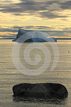 Stranded iceberg and ice near evening in arctic landscape, near Pond Inlet, Nunavut