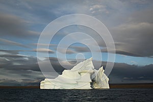 Stranded tabular iceberg and ice near evening in arctic landscape, near Pond Inlet, Nunavut