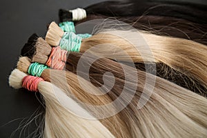 strands of natural women& x27;s hair for encapsulation and extension in a beauty salon.