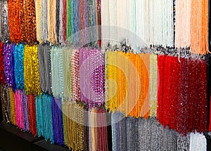 strands of shiny colored glass necklaces in many colors for sale in the shop specializing in personalized jewelery creations photo