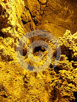 Strange and beautiful yellow pattern of stone texture of Ali Sadr cave walls, Hamedan, Iran photo