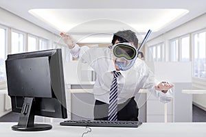 Strange businessman with goggles in office