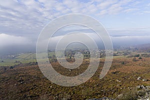 Strange clouds sit over a foggy Hope Valley in the Derbyshire Peak District