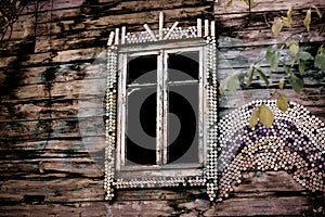 A strange dark mysterious window with broken glass in an old abandoned wooden broken spooky house. Abstract background