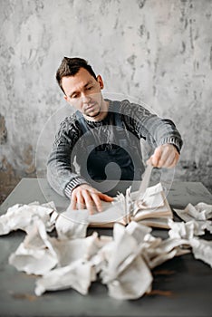 Strange freak man rips the sheets from book