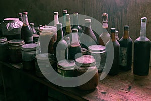 Dusty old glass bottles with very suspicious content