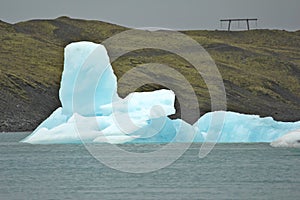 Strange iceberg in front of a hill