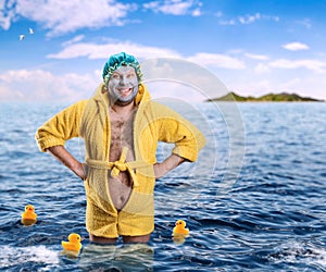 Strange man with face pack stands in water