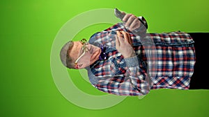 Strange man in funny glasses amusing talking with phone webcam.