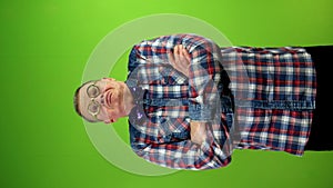 Strange man in funny glasses looking at camera and crossing arms over his chest.