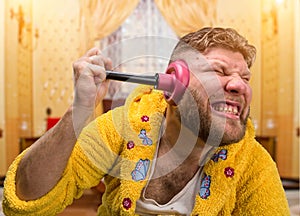 Strange man with a plunger in his ear