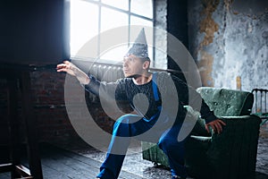 Strange man in tinfoil cap reaches out to TV, UFO