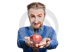 A strange office man with a big head offers an apple. transformed image.