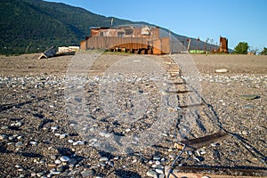 Strange rusty building on the sand