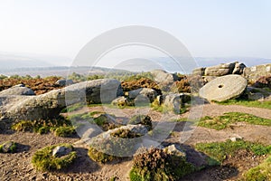 Strange shaped rocks and abandoned millstones on a misty autumn morning