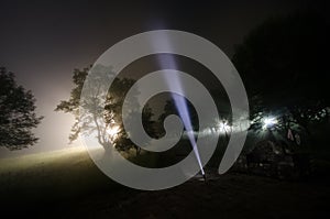 Strange silhouette in a dark spooky forest at night, mystical landscape surreal lights with creepy man