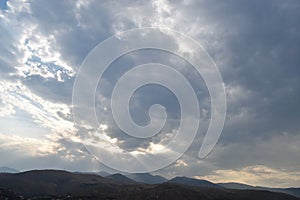 Strange view of a cloudy sky with the sun`s rays seen from behind the clouds