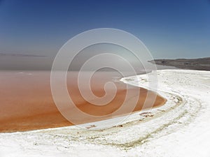 Strange view of Urmia Salt Lake. The salty beach and its red water photo