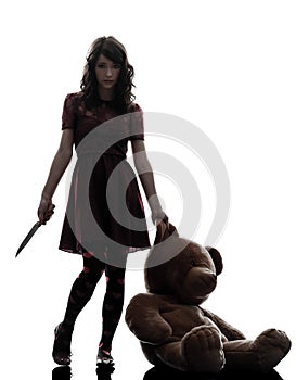 Strange young woman killer holding bloody knife silhouette