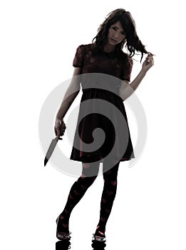 Strange young woman killer holding bloody knife silhouette photo