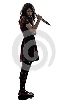 Strange young woman killer holding bloody knife silhouette photo