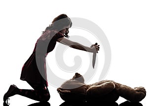 Strange young woman killing her teddy bear silhouette