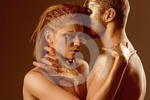 Strangle concept. strangle of girl by man, both have golden paint on body. photo